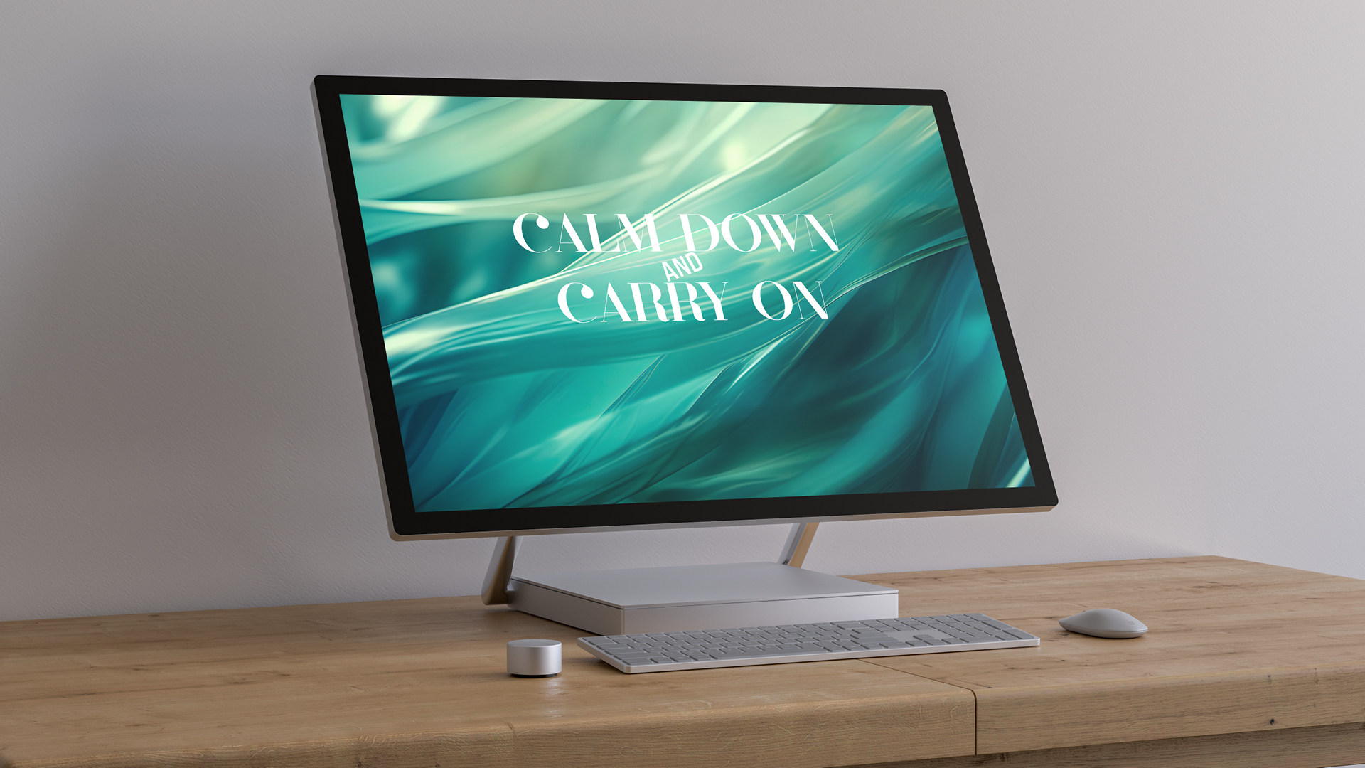 Desktop monitor displaying a digitally-created teal abstract background with white text saying 'Calm Down and Carry On'.