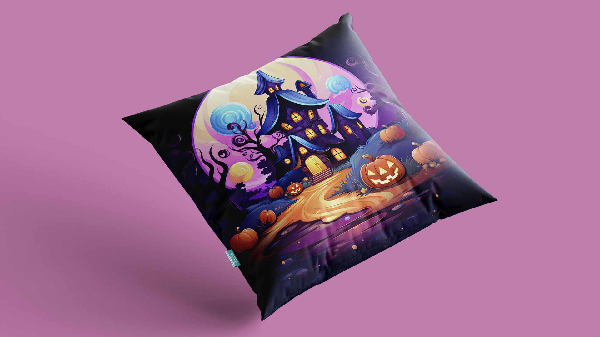 A decorative pillow against a pink background, showcasing a vivid Halloween illustration. The design features a whimsical haunted house with a wavy roof and tall windows, set amidst swirling blue skies. A large carved pumpkin with a glowing face sits on a pathway leading to the house, surrounded by smaller pumpkins and autumn leaves. The scene is illuminated by the light of a large moon in the background